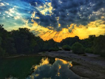 Scenic view of lake against sky at sunset