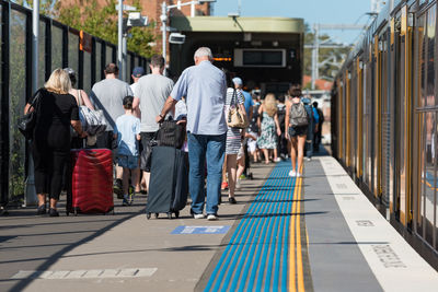 People walking on footpath in city