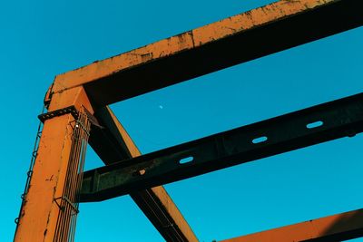 Low angle view of bridge against clear blue sky