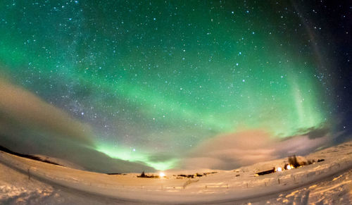 Scenic view of landscape against sky at night