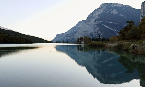 Scenic view of lake and mountains against clear sky