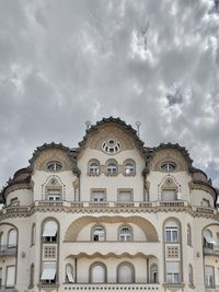 Low angle view of building against cloudy sky