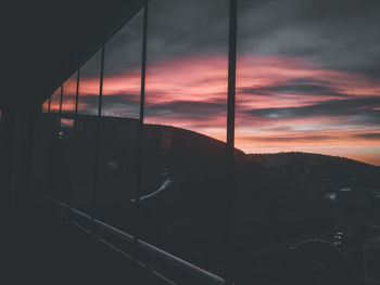 Scenic view of sunset seen through window