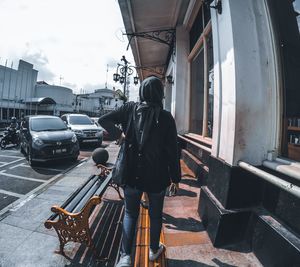 Rear view of man on street in city