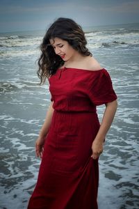 Young woman standing at beach