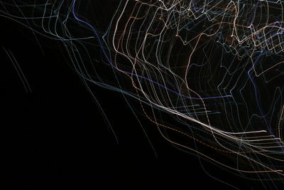 Close-up of illuminated spider web against sky at night