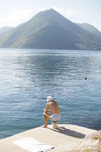 Full length of shirtless man in lake