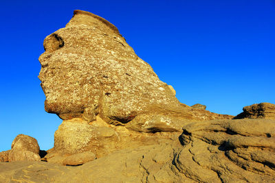 Scenic view of mountains against blue sky