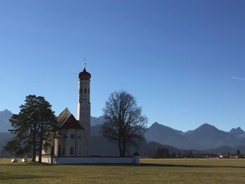 Church by building against sky