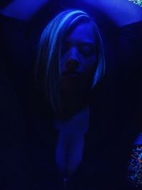 Portrait of woman in dark room