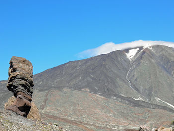 View of mountain range against blue sky