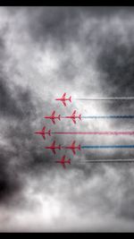 Low angle view of airplane flying against sky