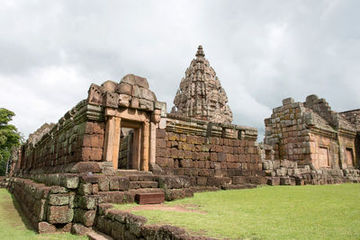 Low angle view of historical building against cloudy sky