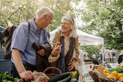 Cheerful senior woman and man enjoying at market