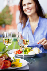 Woman eating salad at outdoor cafe