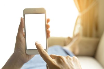 Midsection of man using mobile phone
