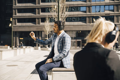 Businessman having video call outside