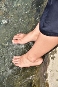 Low section of person legs in water