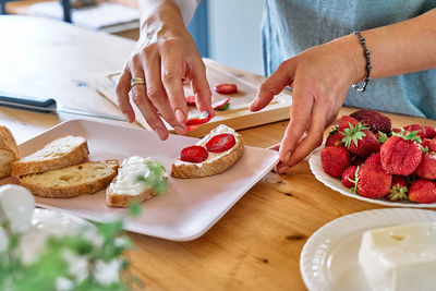 Woman making summer strawberry sandwich. healthy eating, fruit dieting brunch.