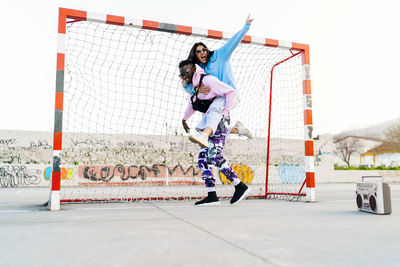 Full length of woman standing against wall