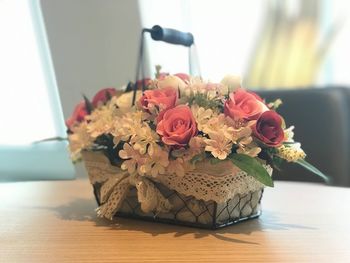 Close-up of roses in vase on table at home