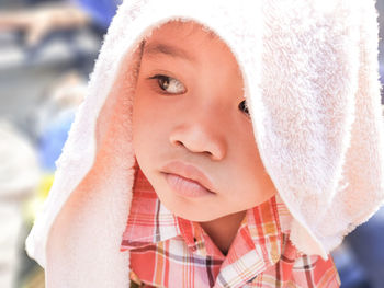 Close-up of cute with towel on head looking away