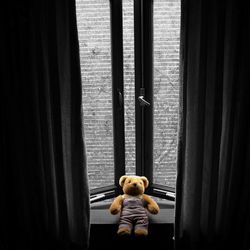 Boy standing by toy car window