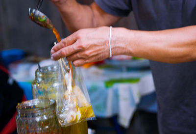 Midsection of man drinking glass