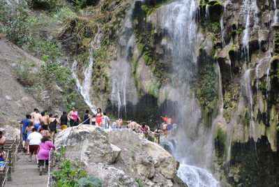 High angle view of people enjoying at waterfall