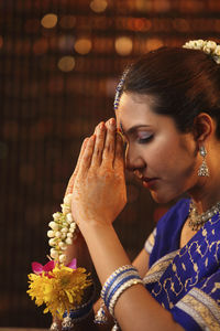 Beautiful indian woman in sari praying during diwali