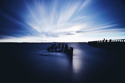 Scenic view of sea against sky at dusk