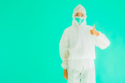 Man standing against blue background