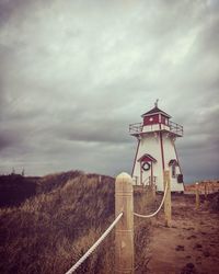 Lighthouse against cloudy sky