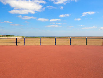 Fence on field against sky