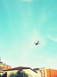 Low angle view of airplane flying in sky