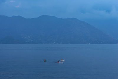 Boats in sea against sky