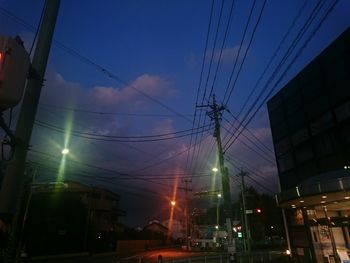 Low angle view of illuminated street light against sky at night