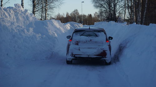 Snow covered car on road