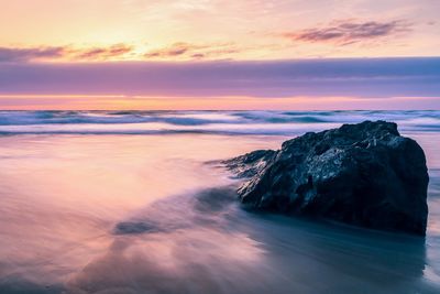 Scenic view of sea against sky at sunset