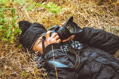 Man photographing on field