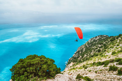 Low angle view of kite flying over sea against sky