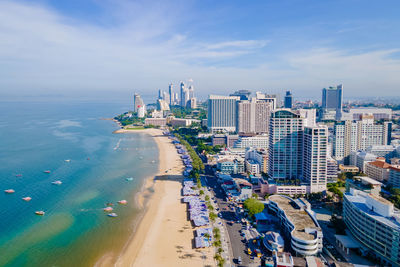 High angle view of cityscape by sea against sky