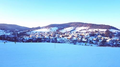 Scenic view of snowcapped mountains against clear blue sky