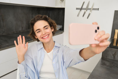 Portrait of smiling woman using digital tablet