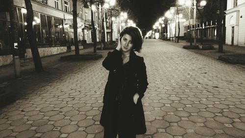 Woman walking on street at night