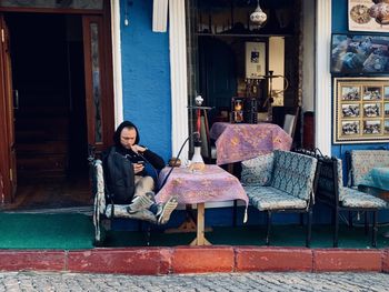 Woman sitting on seat in building