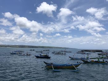 Boats moored in sea against sky