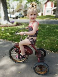 Cute girl riding bicycle on road