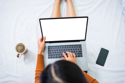 Midsection of woman using mobile phone