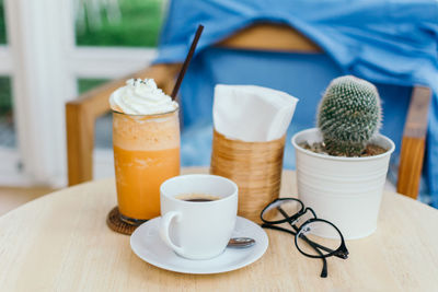 Close-up of drink and cactus on table